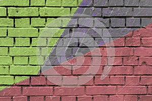 Brick wall with colorful geometric graffiti. Abstract aerosol pattern for background.