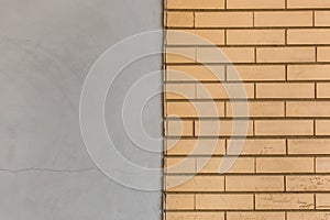 Brick wall and concrete cement grey two colors yellow beige dirty retro color abstract urban background design art texture