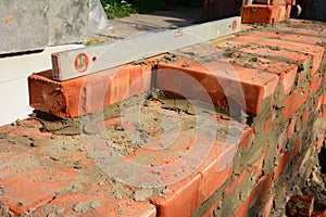 Brick Wall Construction Process with Level Tool