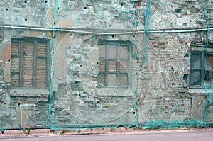 Brick wall covered green facade mesh