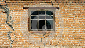 Brick wall with a crack, a window in an old house, the texture of an old house made of red bricks