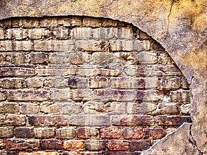 Brick wall with damaged plaster, old background texture