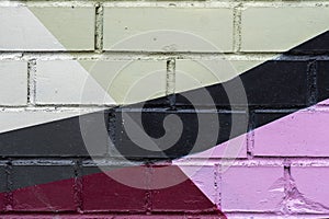 Brick wall is decorated with abstract drawings paint closeup. Detail like as graffiti . Fragment for background