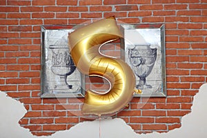 The wall is decorated with the number five.