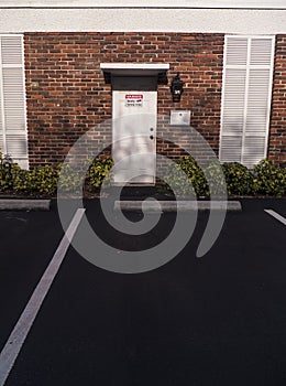 Brick Wall Door Entry Way with a Security Camera Sign