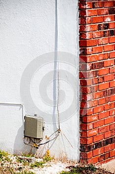 Brick wall edge with white wall accent and power switch box