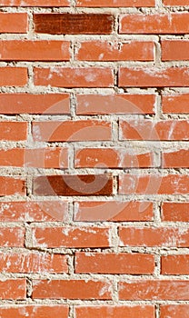 A brick wall with a few bricks missing