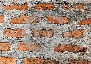 A brick wall with a few missing bricks