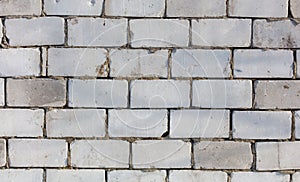 A brick wall with a few missing bricks