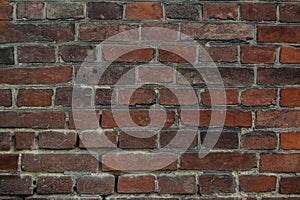 A brick wall with a few missing bricks