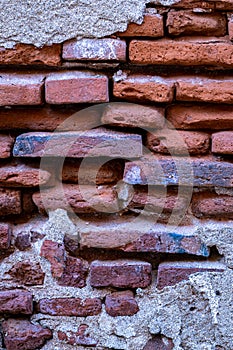 A brick wall with a few missing bricks