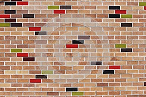 Brick wall with glazed coloured bricks.