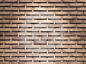 The brick wall has light from on top.Brown brick wall with copy space.