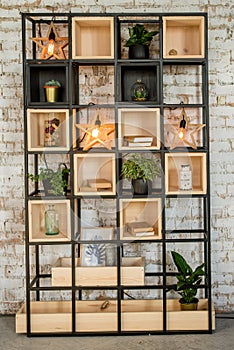 Brick wall home bookshelf with lamp. Interiror in the loft style