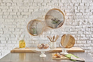 Brick wall interior with round frame and table