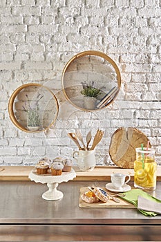 Brick wall interior with round frame and table