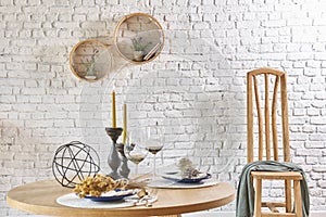 Brick wall interior with round frame and table
