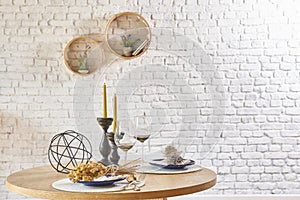 Brick wall interior with round frame and table