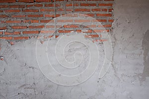 A brick wall mixed with plaster unfinished