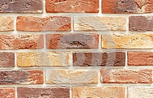 Brick wall of multicolored bricks. Background and texture of brickwork