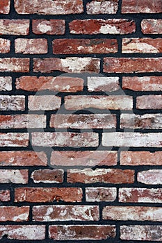 A brick wall newly fitted with concrete seam.