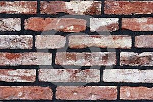A brick wall newly fitted with concrete seam.