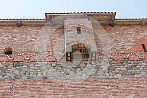 Brick wall of an old castle with toilet rooms