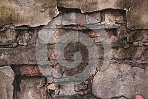 Brick wall of an old destroyed house. Vintage abstract pattern on cement texture. Grunge background. Concrete wall texture.