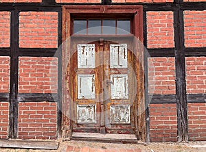 Brick wall with an old weathered door on it