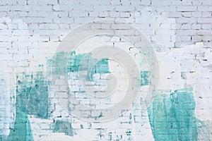 A brick wall painted abstract with white and turquoise paint. Background, texture.