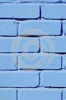 Brick wall painted blue paint close-up. Background.