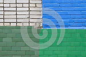 Brick wall painted in different colors by different owners