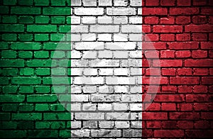 Brick wall with painted flag of Italy
