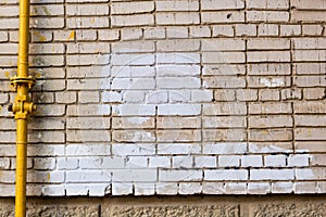 brick wall with painted splotch for your text and paper scraps as background or texture