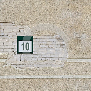 Brick wall and plate with a number ten