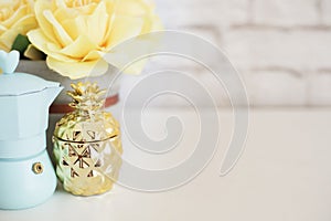 Brick Wall Product Display. Yellow Roses Mock Up. Styled Stock Photography. Blue coffee maker, golden pineapple on white desk. Fas