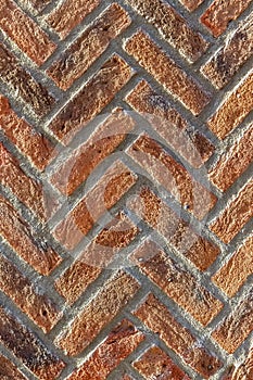 Brick wall. Red texture. Herringbone (V-shaped pattern)
