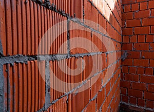 Brick wall of rough masonry. Large bricks in close-up. Walls in roughing. Brick wall texture.