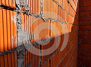 Brick wall of rough masonry. Large bricks in close-up. Walls in roughing. Brick wall texture.