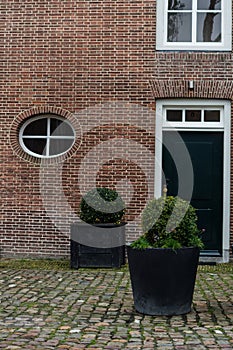 Brick Wall and Round Window, Traditional Dutch House in Veere, Zeeland, Netherlands