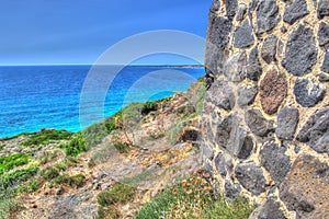 Brick wall by the shore in Sardinia