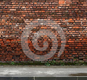 Brick wall with sidewalk