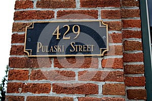 Brick wall with street sign