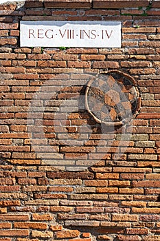 brick wall with symbol in circumference in region VIII in pompeii archeological park