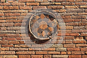 brick wall with symbol in circumference in region VIII in pompeii archeological park