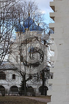 Brick wall and Temple of the Kazan Icon of the Mother of God - church of XVII century behind it.