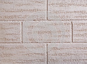 Brick wall texture background, close-up, selective focus. Plain colored stucco, vertical bricks pattern.