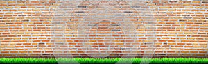 Brick wall texture background with green grass, red brick grunge pattern block