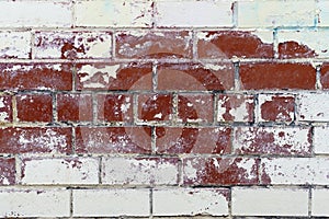 Brick wall textures. Painted problem wall surfaces. Red Stone Background. Worn facade of the building with damaged plaster