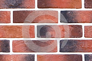 Brick wall with variegated brown bricks. Used as a background.